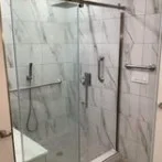 Frameless glass shower with marble-look tile