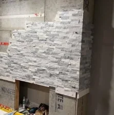 Stacked stone going up over the backer board